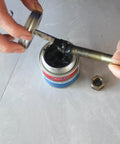 FOTU molybdenum disulfide grease anti-seize thread lubricant can, front view with lid open, coating a bolt beside a hex nut