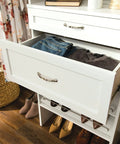 Open drawer in closet tower showing SuiteSymphony Wood Closet Drawer Add On Accessory For 25 Inch Wide Storage Tower Deep 10 Inch Tall Shaker Style Drawer Pure White Finish No Brainer Pick For Undergarments Socks Shirts And Small Garments with folded jeans and gray shirt inside.