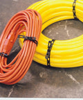 Beefy Heavy Duty 1/2-Inch Black Cable Ties Roll 100-Feet securing coiled cables on a concrete surface