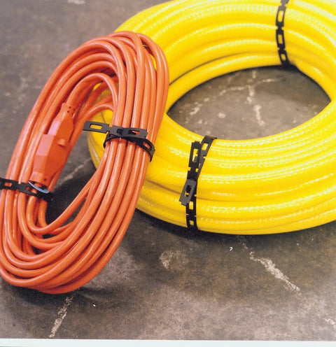 Beefy Heavy Duty 1/2-Inch Black Cable Ties Roll 100-Feet securing coiled cables on a concrete surface