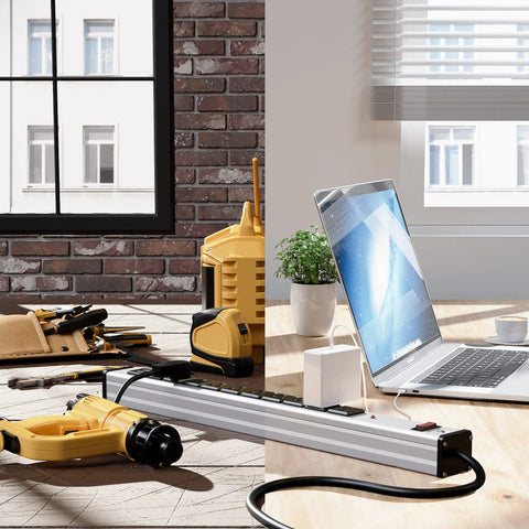 Ten Outlet Aluminum Power Strip With 6 Ft Extension Cord Heavy Duty 15A 125V 1875W Industrial Grade Black Sockets On Silver Housing USB Ports Ideal For Workshop Garage Office School on a desk with tools and a laptop.