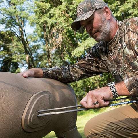 Man removing arrows from Big Buck 3D Target Replacement Core Insert 25 Percent Larger Built To Last For Extended Target Life