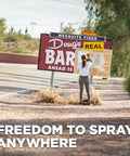 Person using 18V Cordless Paint And Stain Sprayer Delivering Slick HVLP Coatings on a roadside sign.