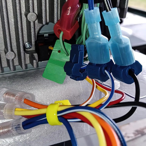 Close-up of Rapid Quick Splice T Tap Connectors Kit For 22-16 AWG Wire in use with colorful wires connected to a device.