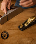 Slick Low Angle Shoulder And Chisel Plane Built For Dead On Edge And End Grain Trimming Boasts An Adjustable Mouth Precision Tuned Steel Blade Plus Includes A Rugged Storage Case on a wooden surface.