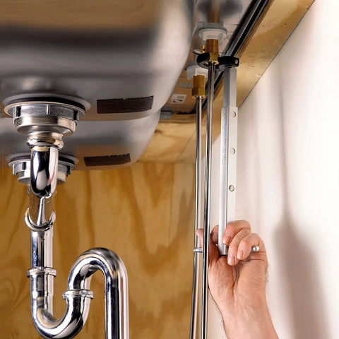 Fold Over Basin Adjustable Pipe Wrench 10 To 17 Inch Telescoping Shank in use under sink with one hand ratcheting grip