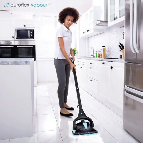 Person cleaning kitchen floor with steam mop and Three Ply Microfiber Floor Pad Replacement Refill For Steam Mops M2R And M4S.