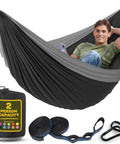 Heavy Duty Nylon Camping Hammock Chair with 500 lb Capacity, double size, man relaxing with phone, tree straps and carry bag included
