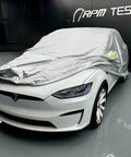 Badass Heavy Duty Weatherproof Car Cover For Tesla Model X Silver Microfiber Weave on a Tesla in a garage setting.