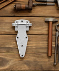 Heavy Duty Freezer Door Hinge Zinc Alloy, Easy Install Pivot Hinge For Household Freezers And Industrial Refrigeration, Tough, Reliable, Compact Design For Safe And Secure Door Operation displayed with tools on wooden surface