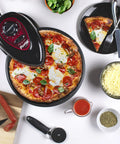 Pizzazz Plus Rotating Countertop Oven With Even Bake Tech shown atop pizza on included rotating tray, ingredients nearby.