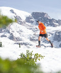 Trail Crampon Ultra I Ice Cleat Traction System For Hiking And Trail Running with runner on snowy terrain