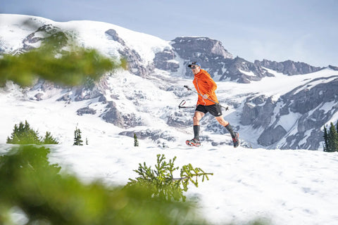 Trail Crampon Ultra I Ice Cleat Traction System For Hiking And Trail Running with runner on snowy terrain