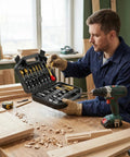 Man holding Top Shelf 26 Piece Woodworking Drill Bit Set With Heavy Duty HSS Step Bits, tools in case on workbench.