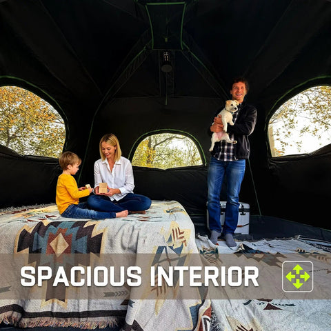 Roomy Six Person Camping Tent With Heavy Duty Blackout Layer Blocks Bright Morning Sun And Keeps Things Cool For Your Crew Includes Full Rainfly For Smooth Weekend Getaways, spacious interior with family sitting.