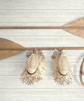 White Shiplap Peel and Stick Wallpaper Roll, DIY Friendly featuring decorative wooden oars, hats, and rope against the wallpaper.
