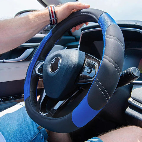 Slick Microfiber Leather Steering Wheel Cover Universal 14.5 To 15 Inch Anti Slip Padded Grip For Cars Trucks And Suv With Stylish Black Blue Stitching For Bone Comfy Drives on a steering wheel.