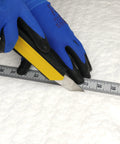 Ceramic fiber insulation blanket, 1 in thick, white, being cut with a yellow utility knife