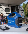 Go-To Portable Power Station With 155Wh 150W Peak on table with phones, camping site in background
