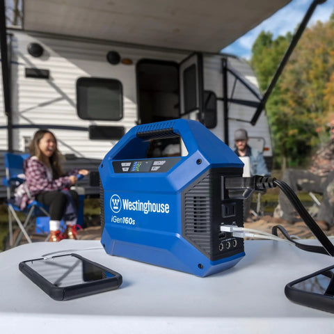 Go-To Portable Power Station With 155Wh 150W Peak on table with phones, camping site in background