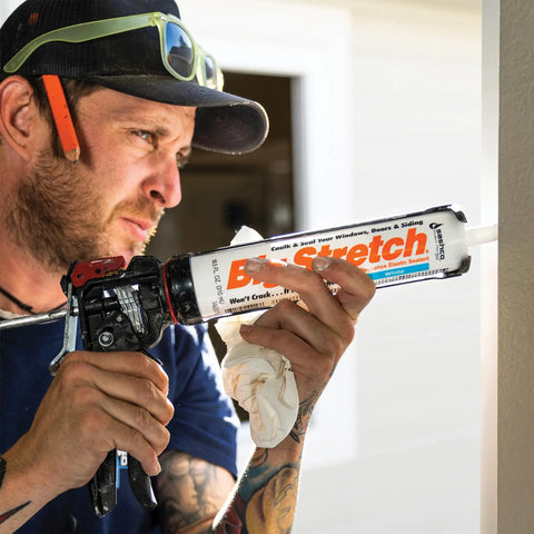 High Performance Elastic Sealant Cartridge 10.5 Oz In Natural Sandstone used by a contractor applying it to a wall.