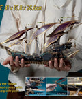 Person holding Vintage Steampunk DIY Mechanical Model Kit for the Corsair Airship in Deep Green, showing hollow frame and sails.