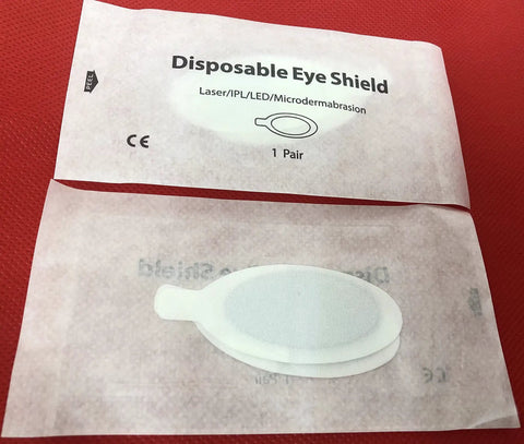 Premium Disposable Laser And Ipl Led Eye Shields Pro Grade Cosmetics Safety Pads Od7 Uv Blocking Heavy Duty Spa Facial Treatments 50 Pairs Black packaging with eye shield for client protection.