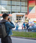 Walker Pro 24L Camera Backpack For Photography And Video Gear With Front Panel Access worn by person taking photo on urban street
