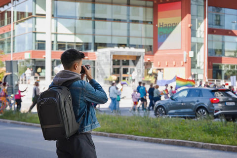 Walker Pro 24L Camera Backpack For Photography And Video Gear With Front Panel Access worn by person taking photo on urban street