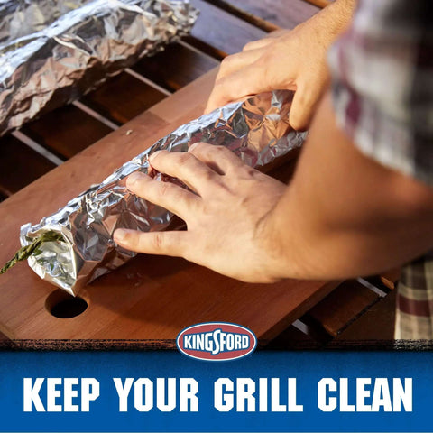 Hands wrapping food in Extra Wide Aluminum Foil Roll For Grilling And Baking Heavy Duty 18 Inch By 100 Sq Ft on a wooden surface.