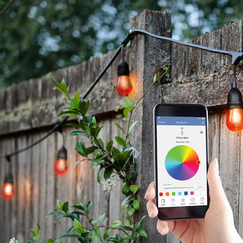Smart WiFi String Lights 24 Inch 12 Pack Color Changing RGBW With Scheduling, Alexa And Google Assistant Compatible Dope Outdoor Setup hanging on fence with phone app control.