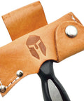 Close-up of Five In One Survival Hatchet Head in leather sheath, carbon steel tool visible, for real world field tasks.