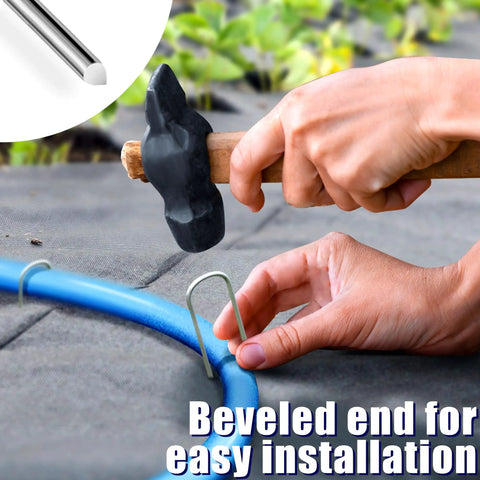 Installing 50 Pack 4 Inch U Shaped Galvanized Garden Stakes For Drip Irrigation And Landscape DIY Projects. Close-up on stake.