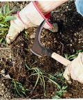 Gardener using portable multifunctional grass clearing sickle for weeding, showing manganese steel handle and non-slip grip.