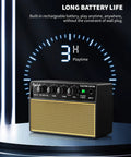 Mini 10W Rechargeable Guitar Amp With Bluetooth on table, showcasing long battery life indicator and control knobs.
