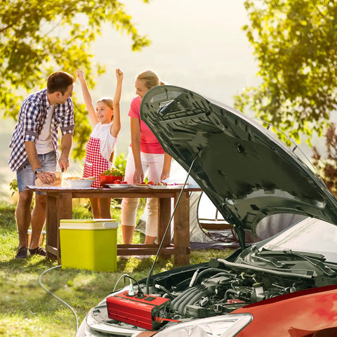 Family using the 2000W Car Power Inverter 12V To 110V AC Converter With 4000 Watt Surge while cooking outdoors.