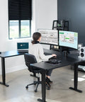 Rock Solid U Shaped Standing Desk Converters 83 By 60 Inches Black Sit Stand Converter with dual monitors in a workspace.