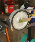 Heavy Duty 2X48 Belt Bench Grinder Attachment With 8 Inch Contact Wheel And 7 Inch Disc in action sharpening a knife with sparks.