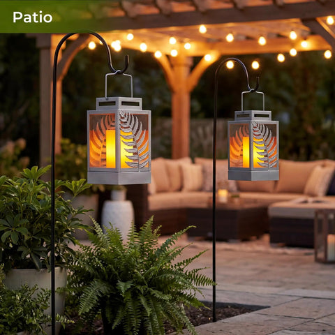 Outdoor Solar Lanterns With Flickering Flame 2 Pack Rustproof Metal LED Lights hanging on hooks in a patio setting