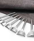 Seven Piece Leather Craft Tool Set With Half Round Arc Shaped Punches For Straps Belts Wallets And Bags DIYers Handwork Pro Grade Leatherworking Kit With Seven Size Range From 10mm To 40mm Durable Steel shown against a fabric backdrop.