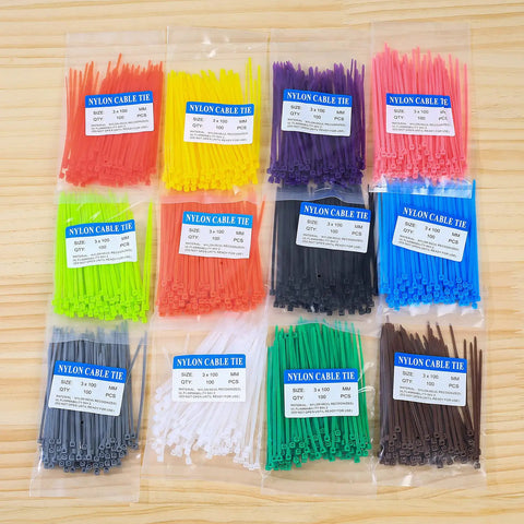 Massive 1200 Pack Multicolor Zip Ties 4 Inch Self Locking Nylon Cable Ties Set In 12 Colors For Home Office Garden Garage Workshop UV And Heat Resistant PA66 Durable Easy To Use Cable Management For Cables And More displayed in packaged sets on a wooden surface.