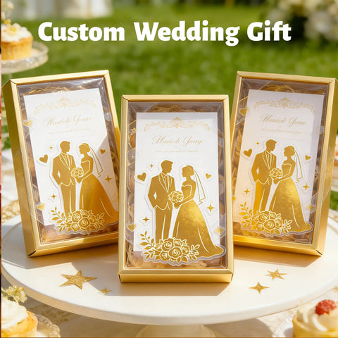 Custom wedding gift boxes with gold silhouette of couple, elegant floral design, and 'Thank You' note on table outdoors.