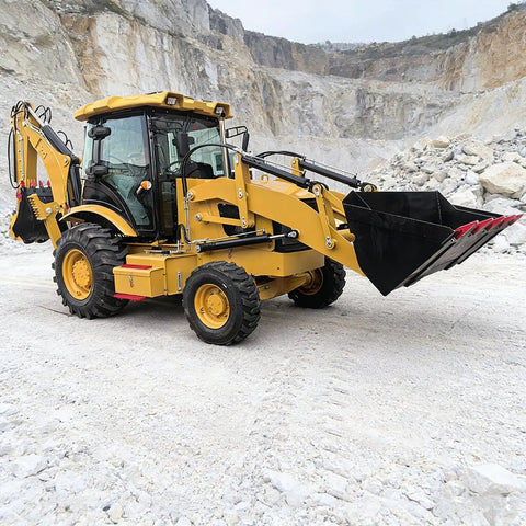 Yellow towable compact backhoe loader with front end loader and rear backhoe in quarry for remote construction and utility work