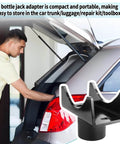 Beefy Heavy Duty Bottle Jack Axle Adapter Lifting Saddle Cradle next to open car trunk, compact size for easy storage