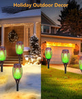 Outdoor Solar Torch Lights For Garden Decor 4 Pack 12 LED Waterproof Torches With Flickering Flame illuminating a winter and summer yard