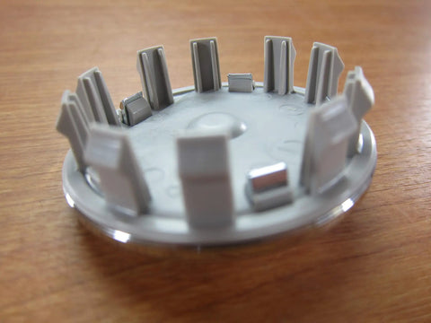 Silver Ram 1500 DT Wheel Center Cap With Ram Logo OEM Replacement For 2019 New Body Style Direct Fit Factory Spec Rim Center Cap With Built To Last Construction And Slick Look, underside view showing clip detail.