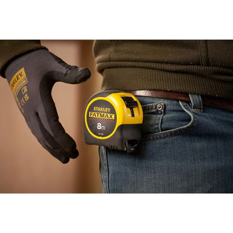 Man holding Tape Measure With Blade Armor Built Tough 8 M Metric, Shock Resistant, Mylar Coating on belt loop
