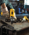 Worker using Corded Drill Powerhouse With 1/2-Inch Chuck, 10 Amp Motor, Mid Handle Grip in a workshop, drilling metal.