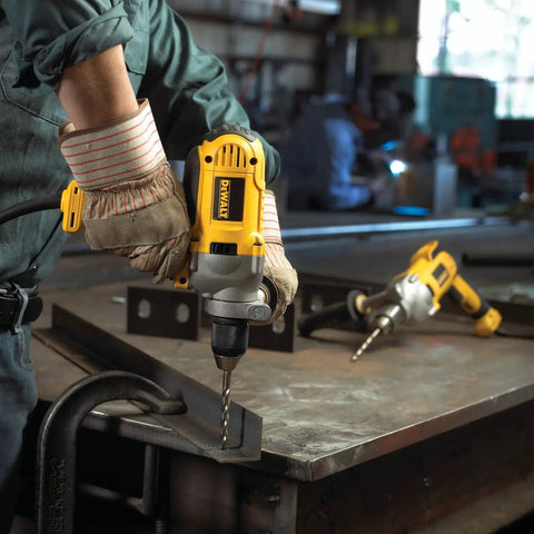 Worker using Corded Drill Powerhouse With 1/2-Inch Chuck, 10 Amp Motor, Mid Handle Grip in a workshop, drilling metal.