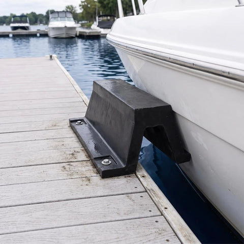 Rugged Rubber Bolt Down Dock Protection For Marinas and Piers Keeps Your Boats Safe From Impacts With Easy Secure Install No Fuss, Shock Absorbing Dock Bumper For Waterfront Use installed on wooden pier with boat contact